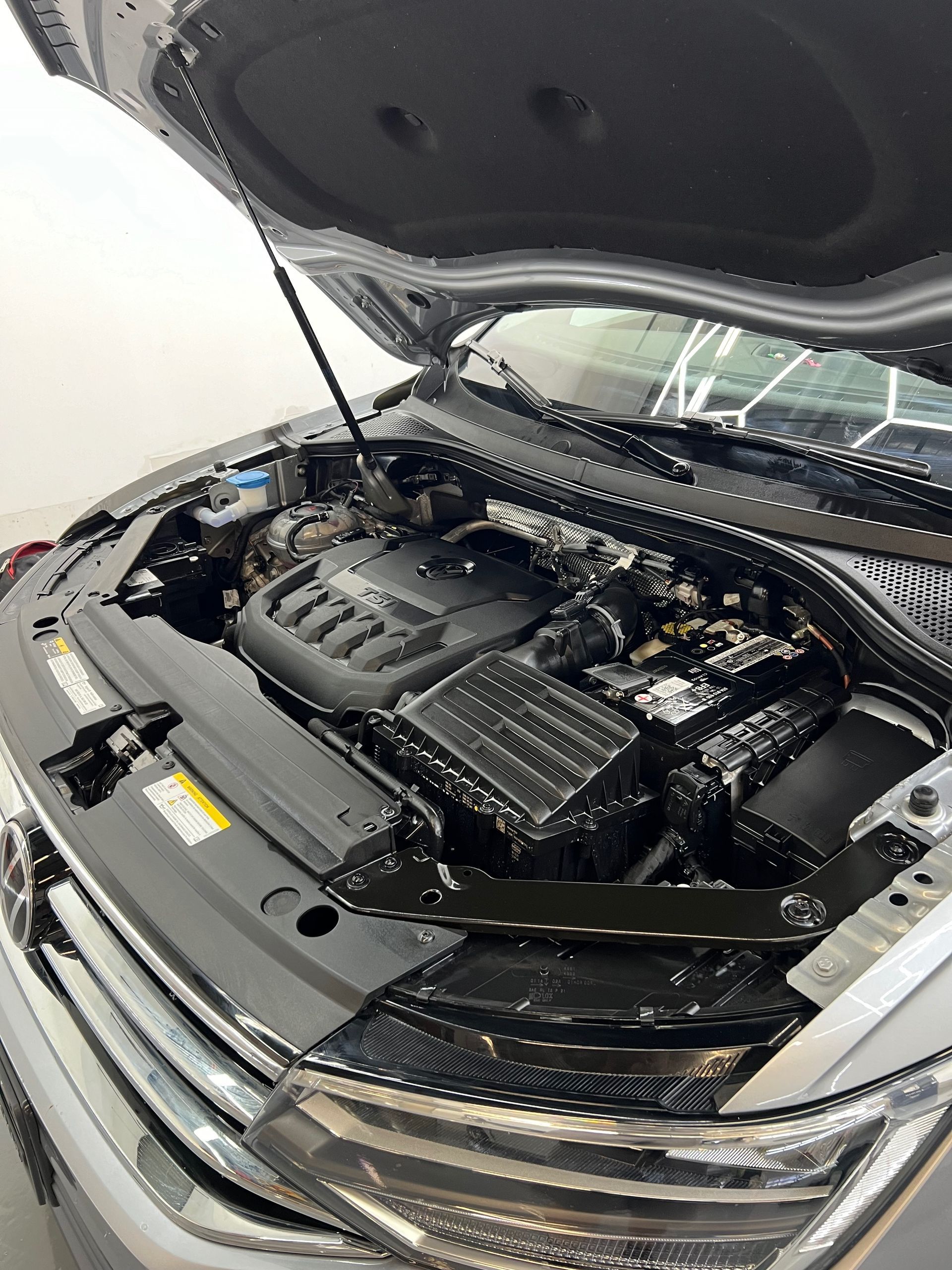 The engine of a car is shown with the hood open.