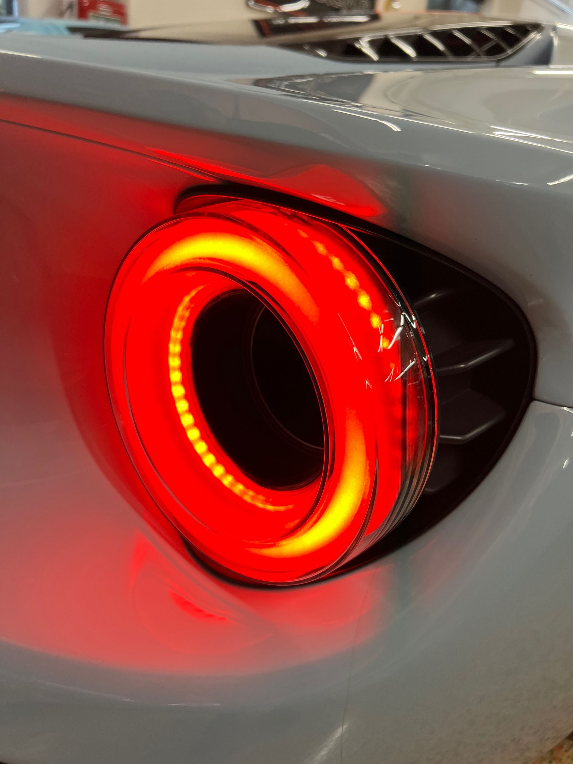 A close up of a red tail light on a car