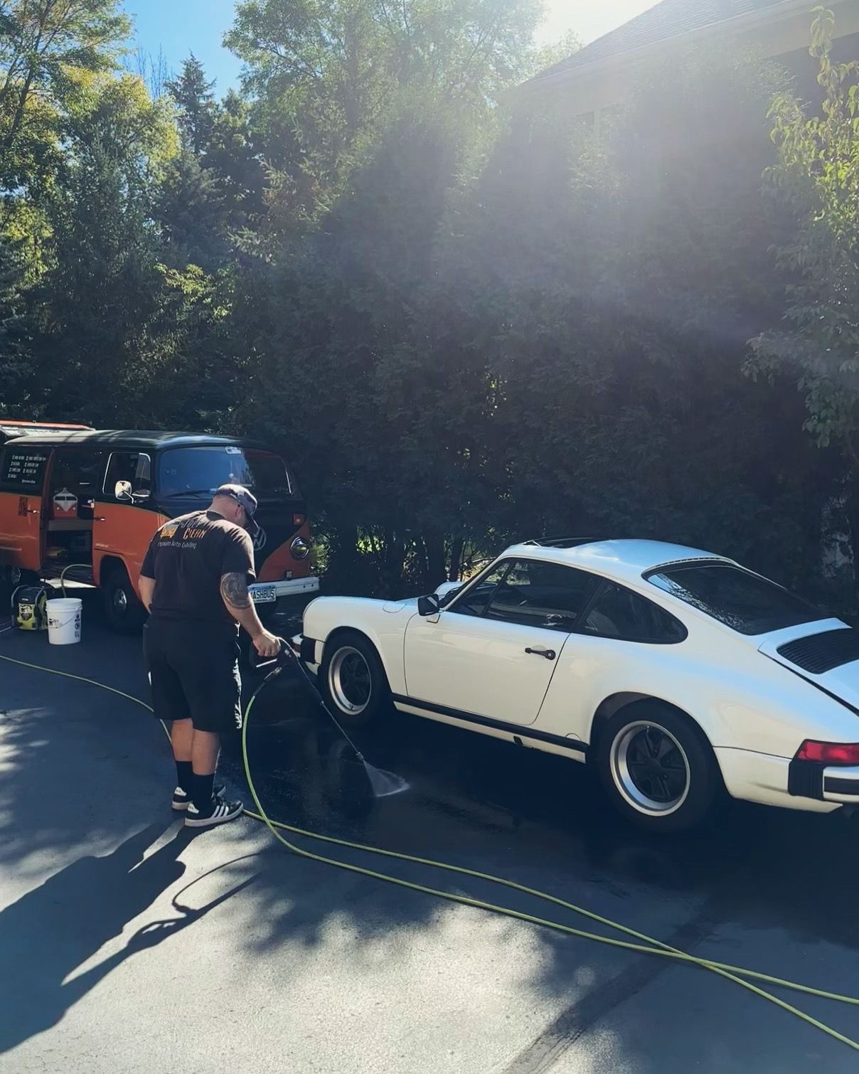 A man is standing next to a white sports car