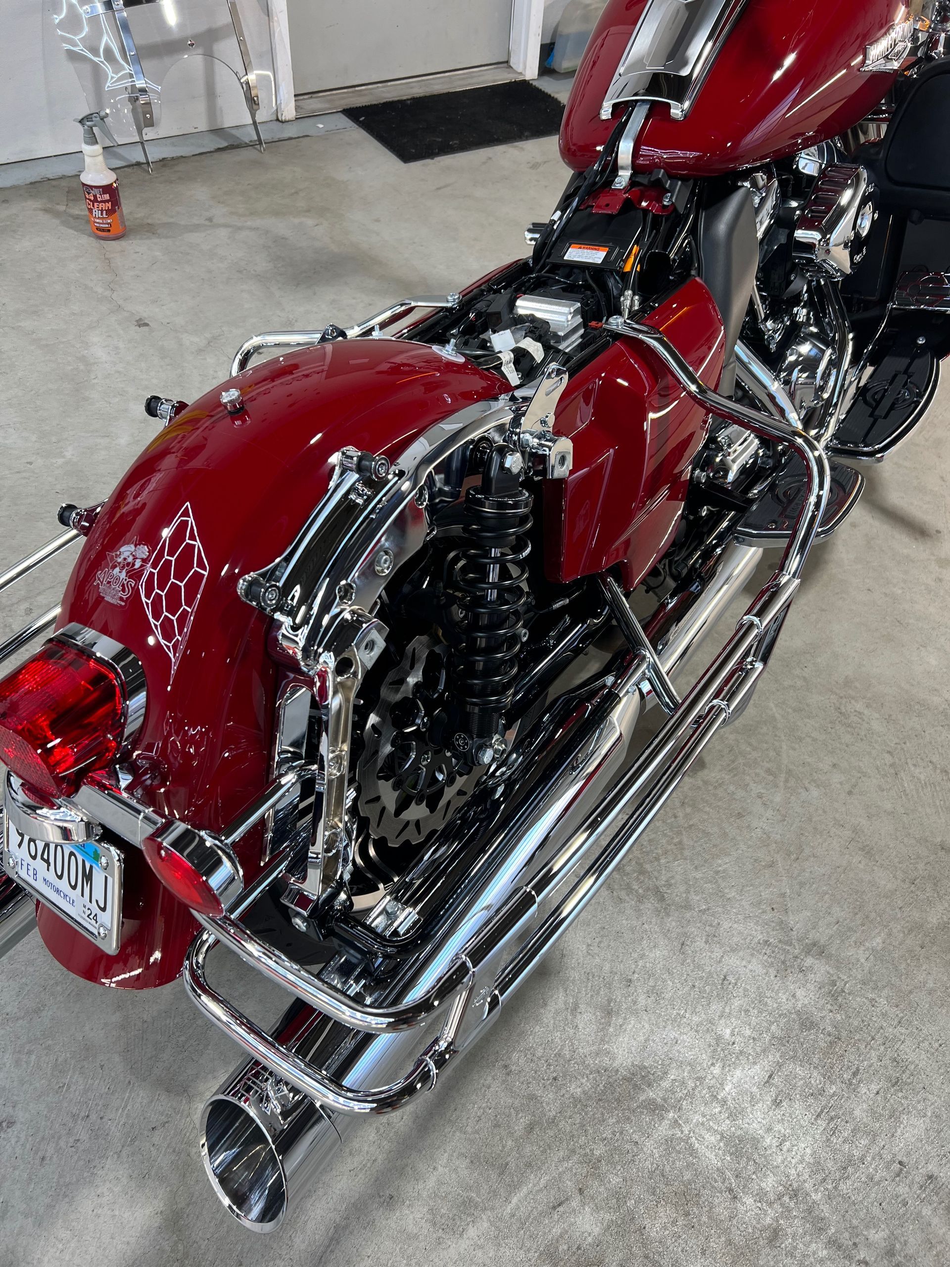 A red harley davidson motorcycle is parked in a garage