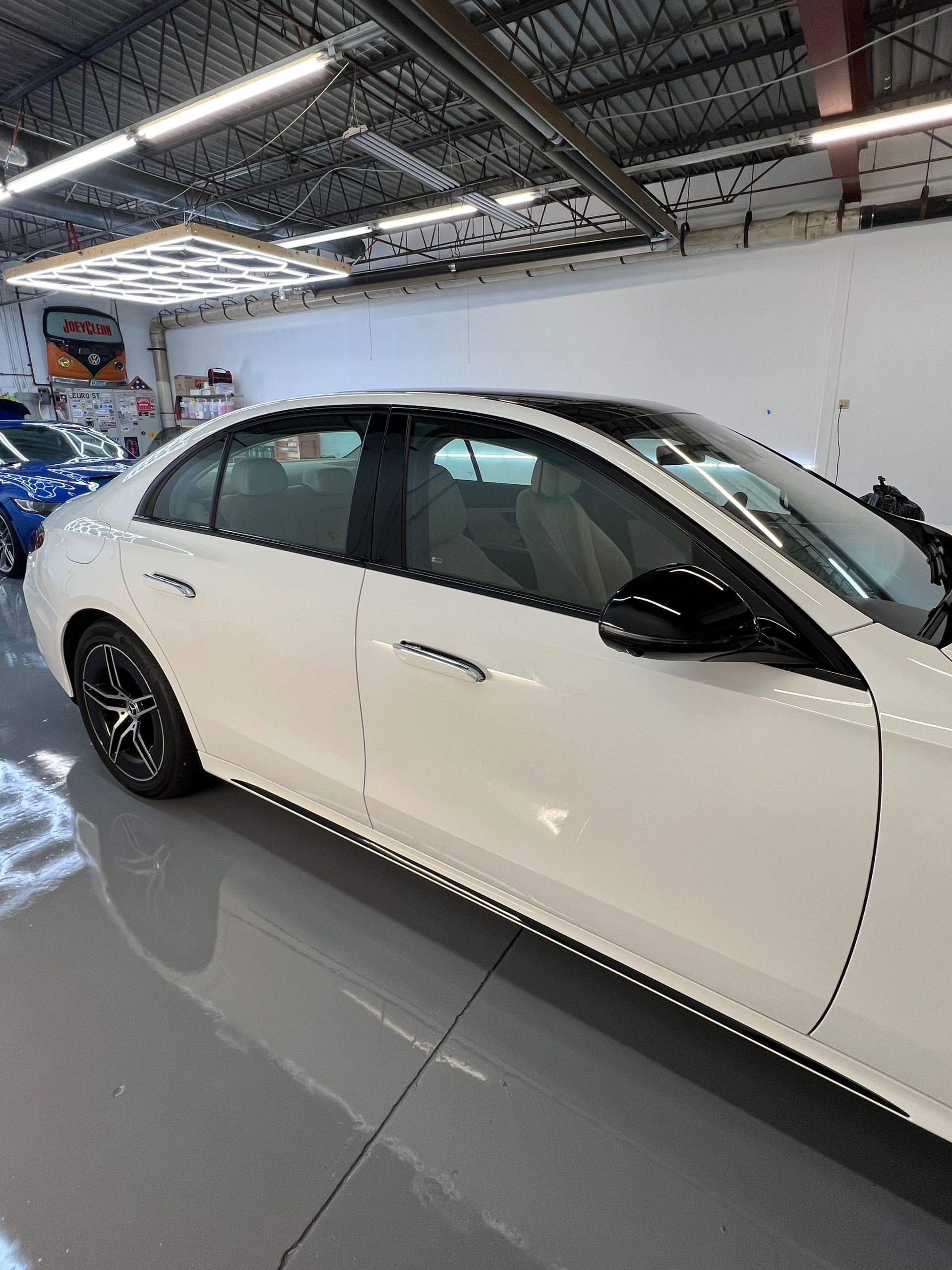 A white car is parked in a garage.