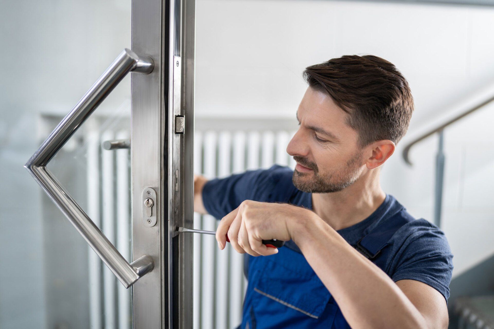 A professional doing a commercial door frame repair in Columbia City, IN