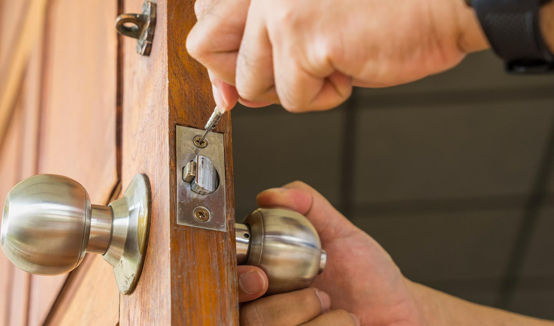 Lock Installation — Man Installing Door Lock in Fort Wayne, IN