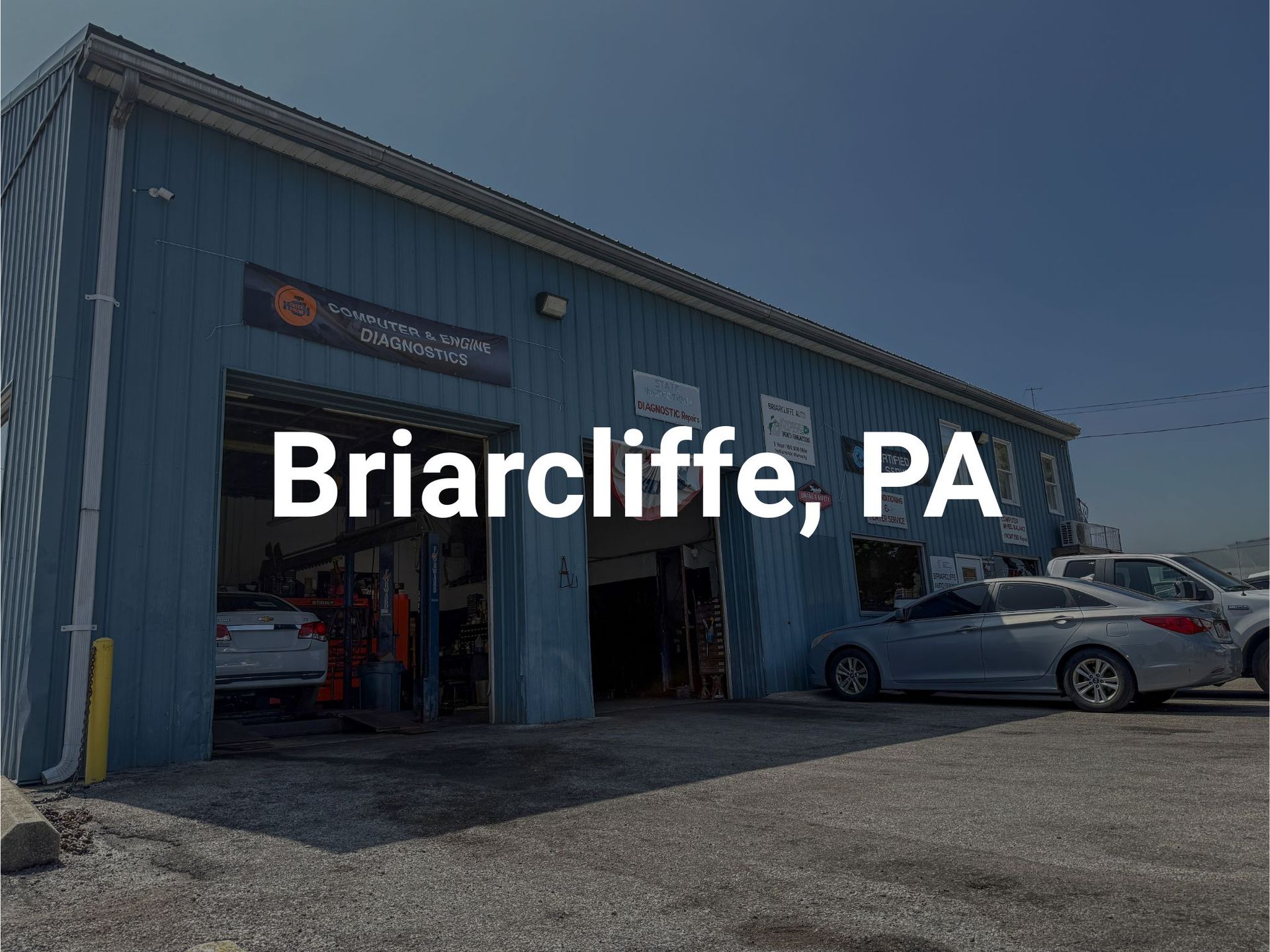 Briarcliffe Auto Service's auto repair shop in Briarcliffe, PA, with open bay doors and parked cars.