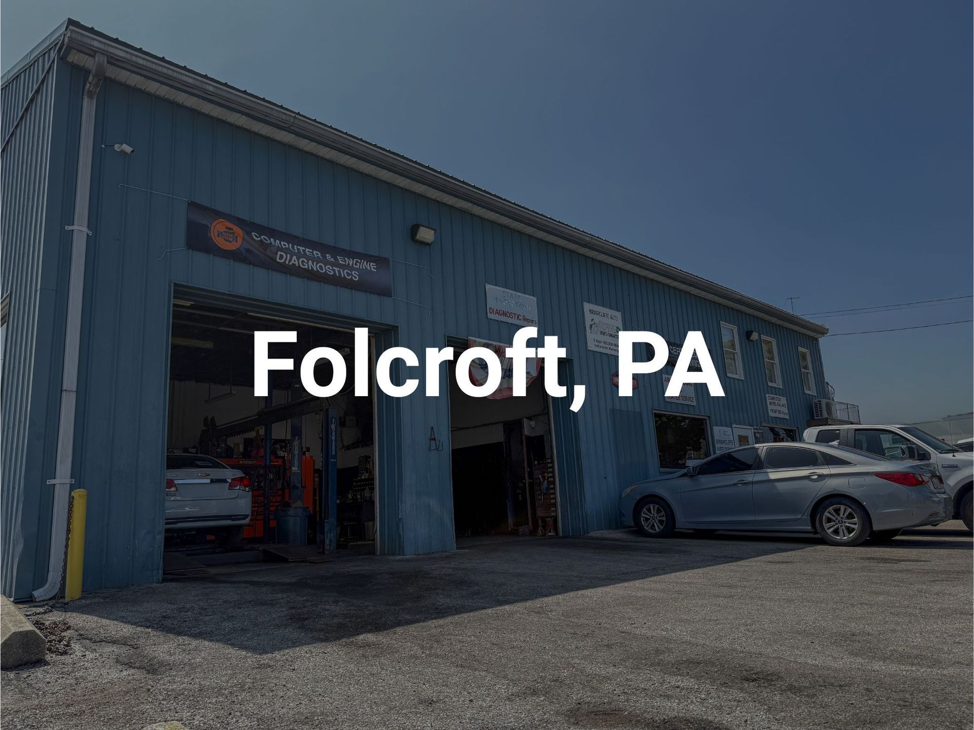 Briarcliffe Auto Service's auto repair shop in Briarcliffe, PA, with open bay doors and parked cars.