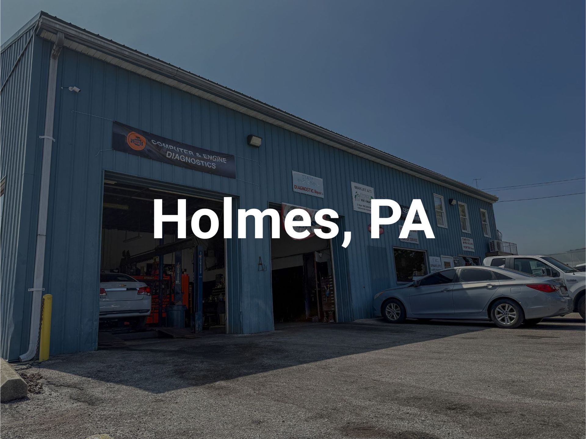 Briarcliffe Auto Service's auto repair shop in Briarcliffe, PA, with open bay doors and parked cars.