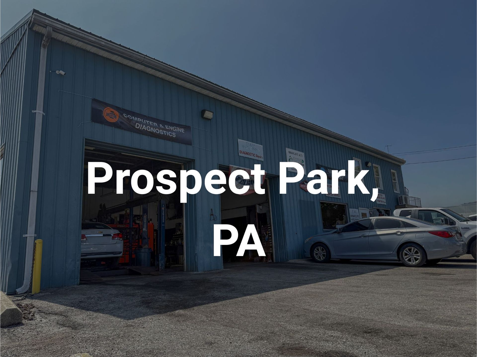 Briarcliffe Auto Service shop in Glenolden, PA with open bay doors. Several cars are parked outside in a parking lot.