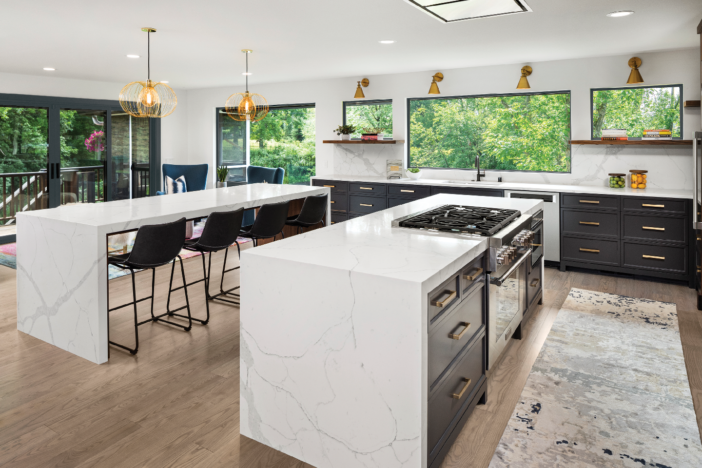 A kitchen with a large island and a stove top oven.