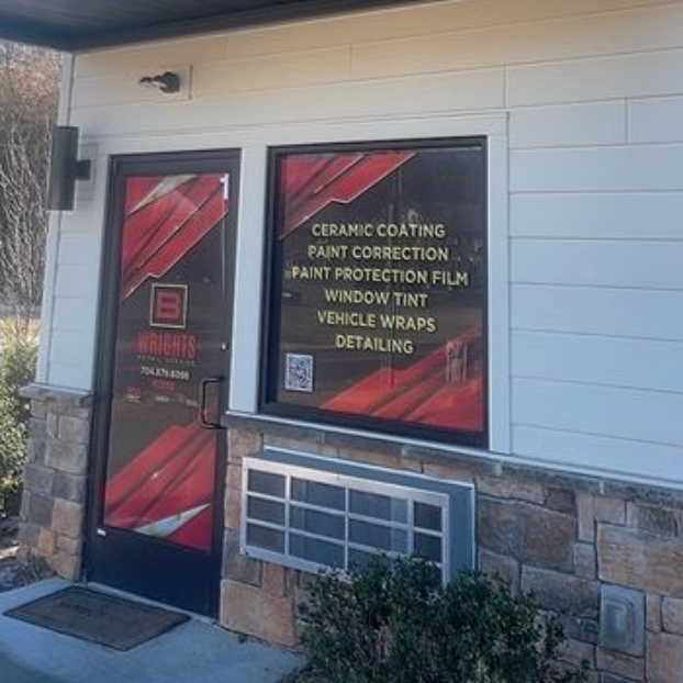 Exterior of B Wrights Detail Service shop with a sign and service offerings listed on windows.