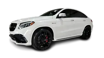 White Mercedes-Benz SUV coupe with black rims and tinted windows.
