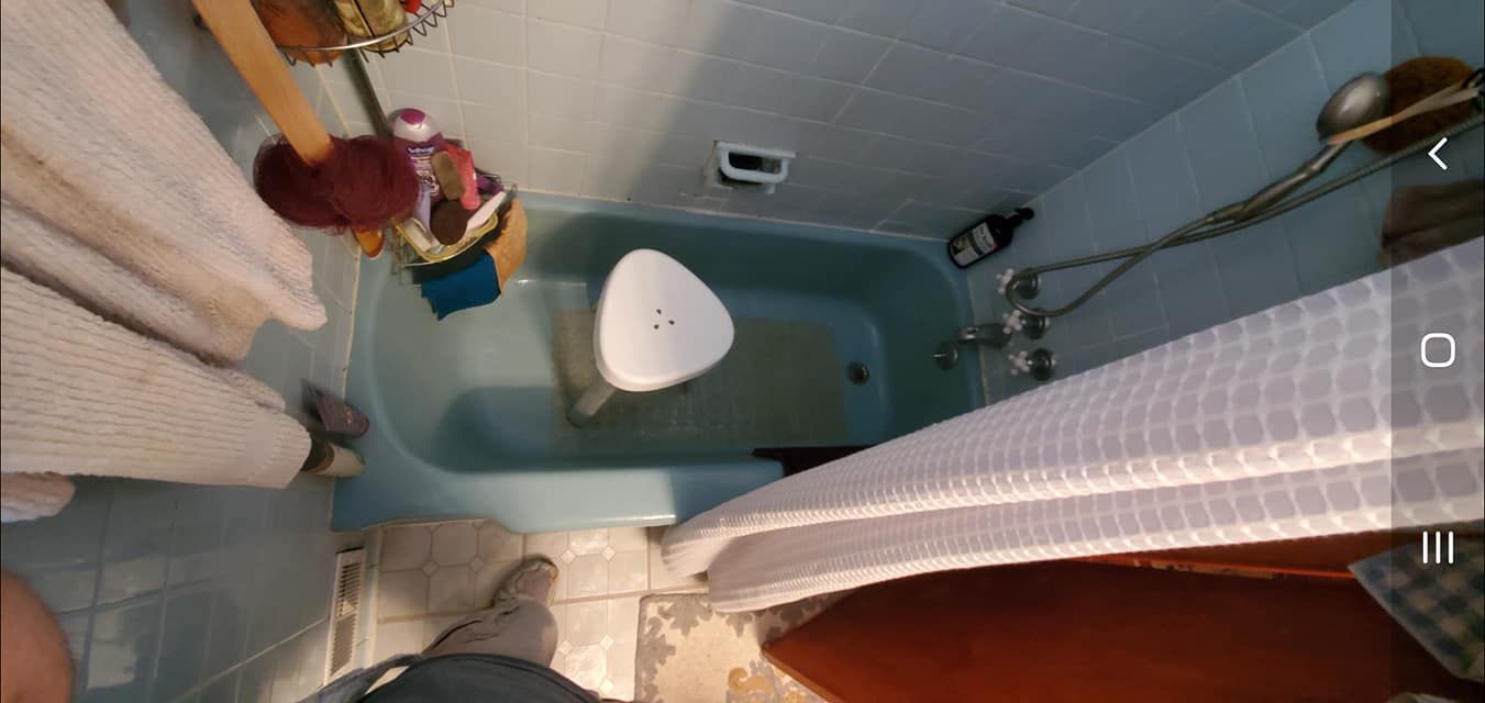 A bathroom with a bathtub and a shower curtain.