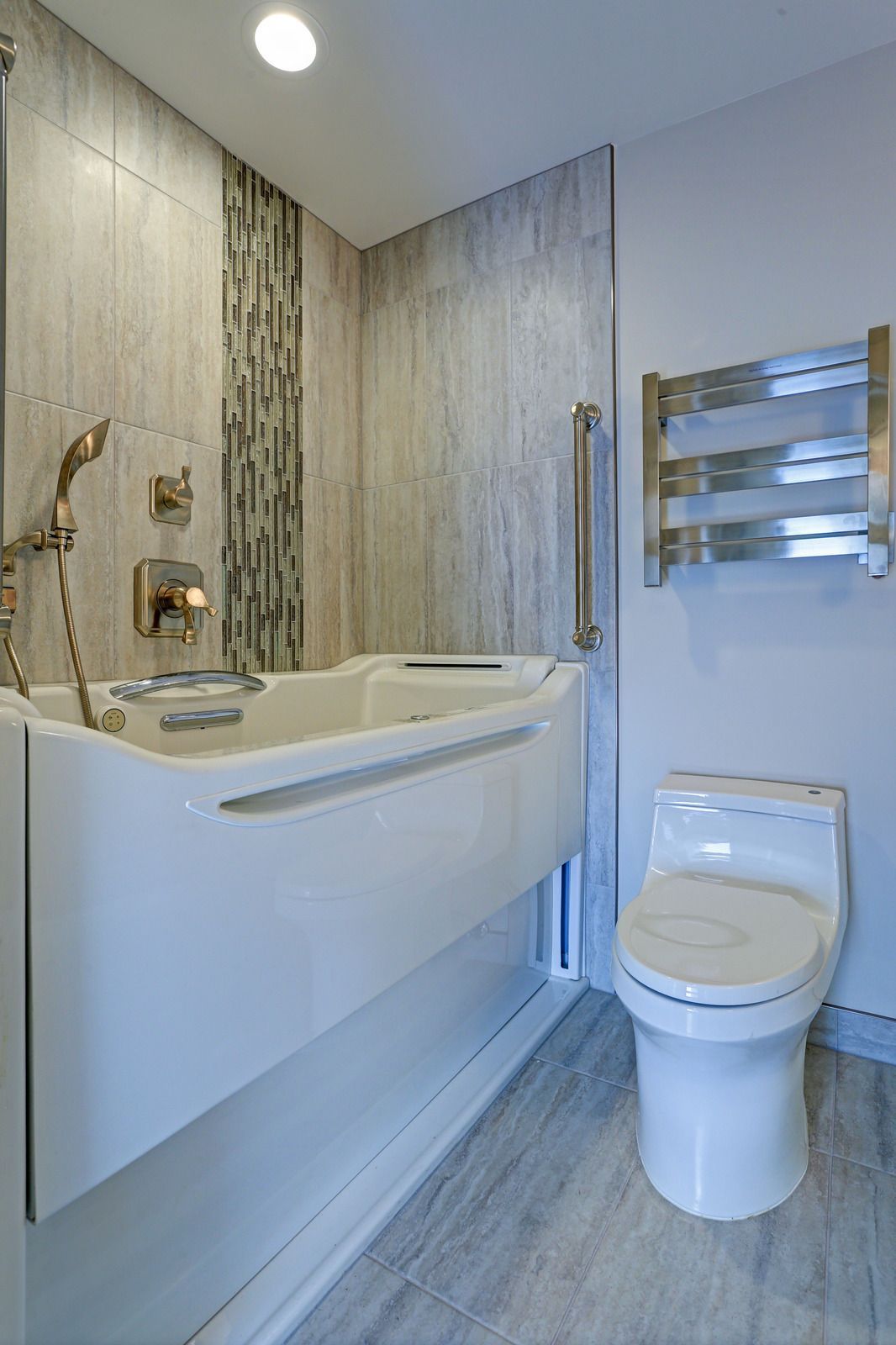 A bathroom with a walk in tub and a toilet.