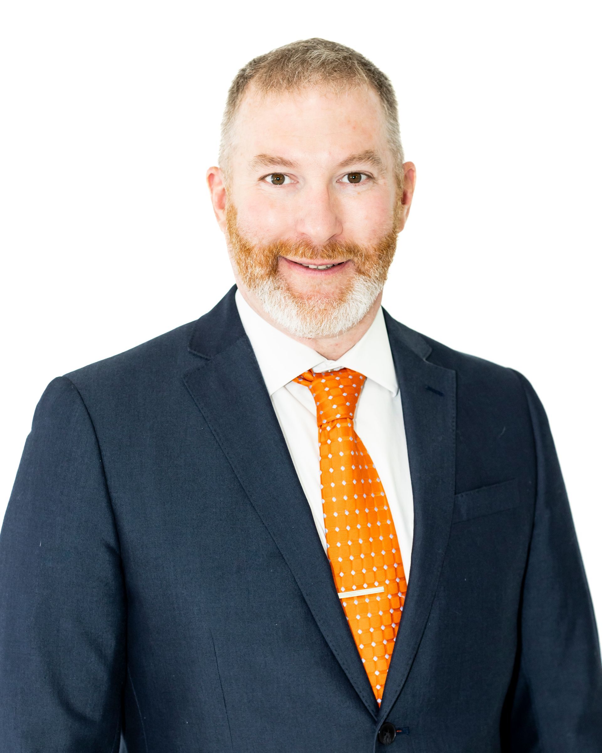 A man in a suit and tie is smiling for the camera.