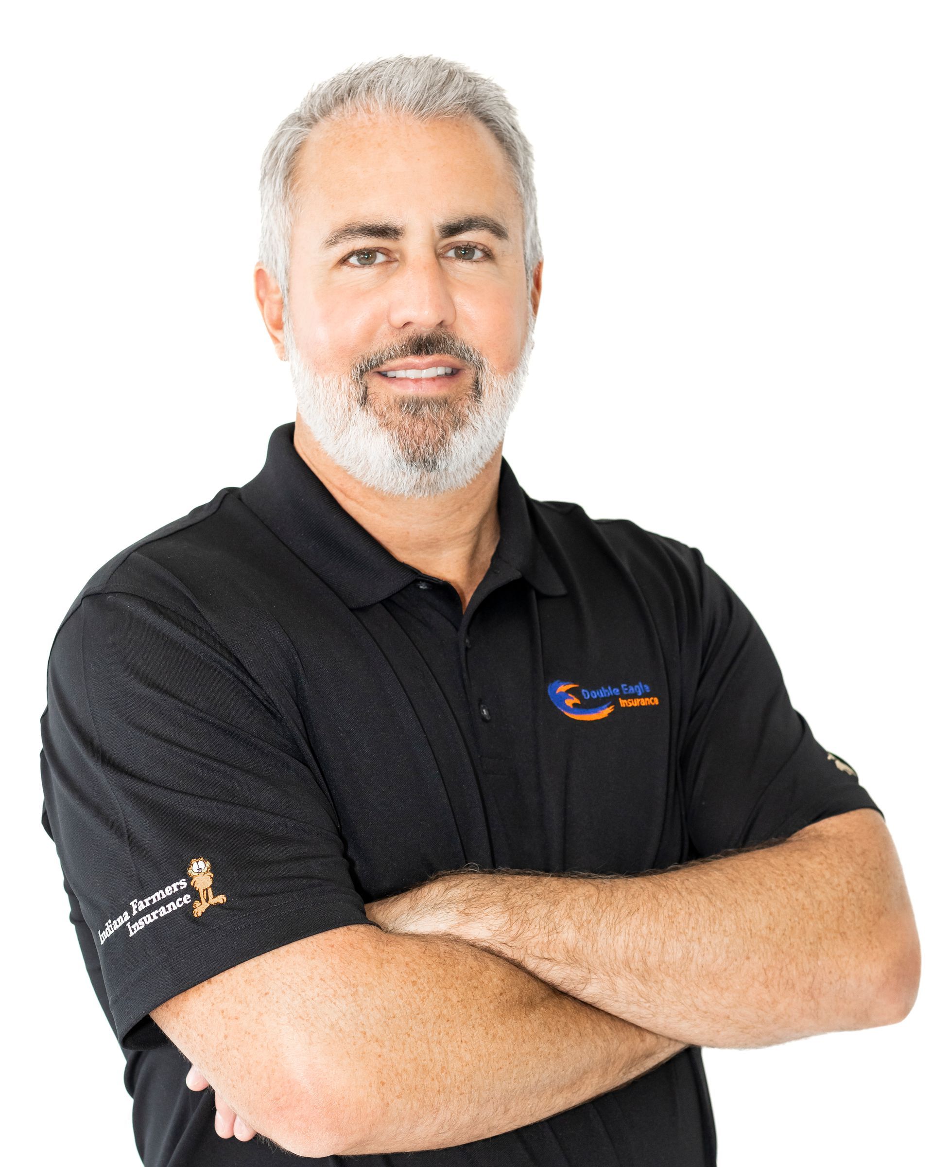 A man with a beard wearing a black shirt with his arms crossed