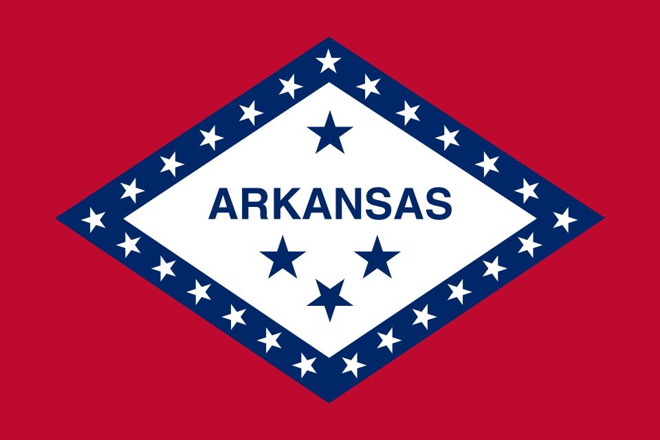 Flag of Arkansas: a red field with a large white diamond bordered in blue, twenty-five white stars, and the word Arkansas with four stars.