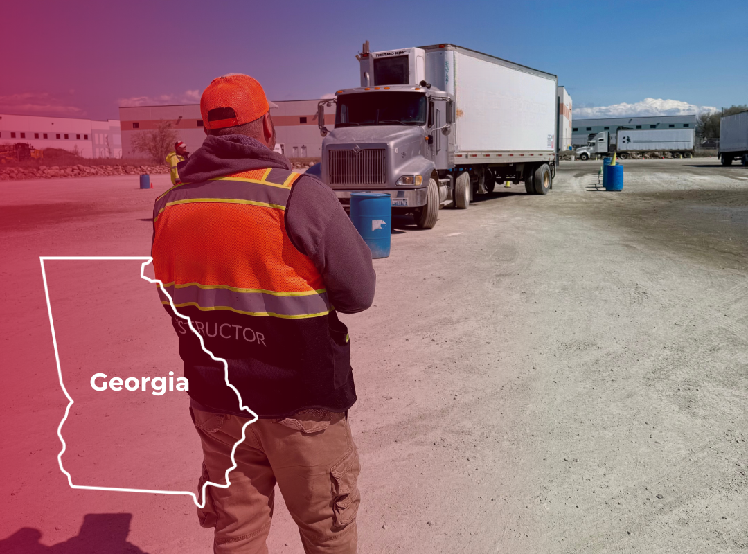 Man in orange vest directing a semi-truck in Georgia.