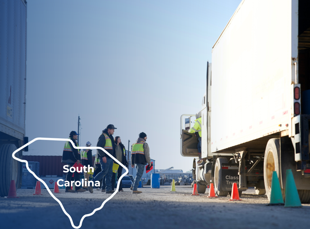 CDL students in safety vests stand near large trucks in a yard, overlaid with a white outline of the state of Tennessee.