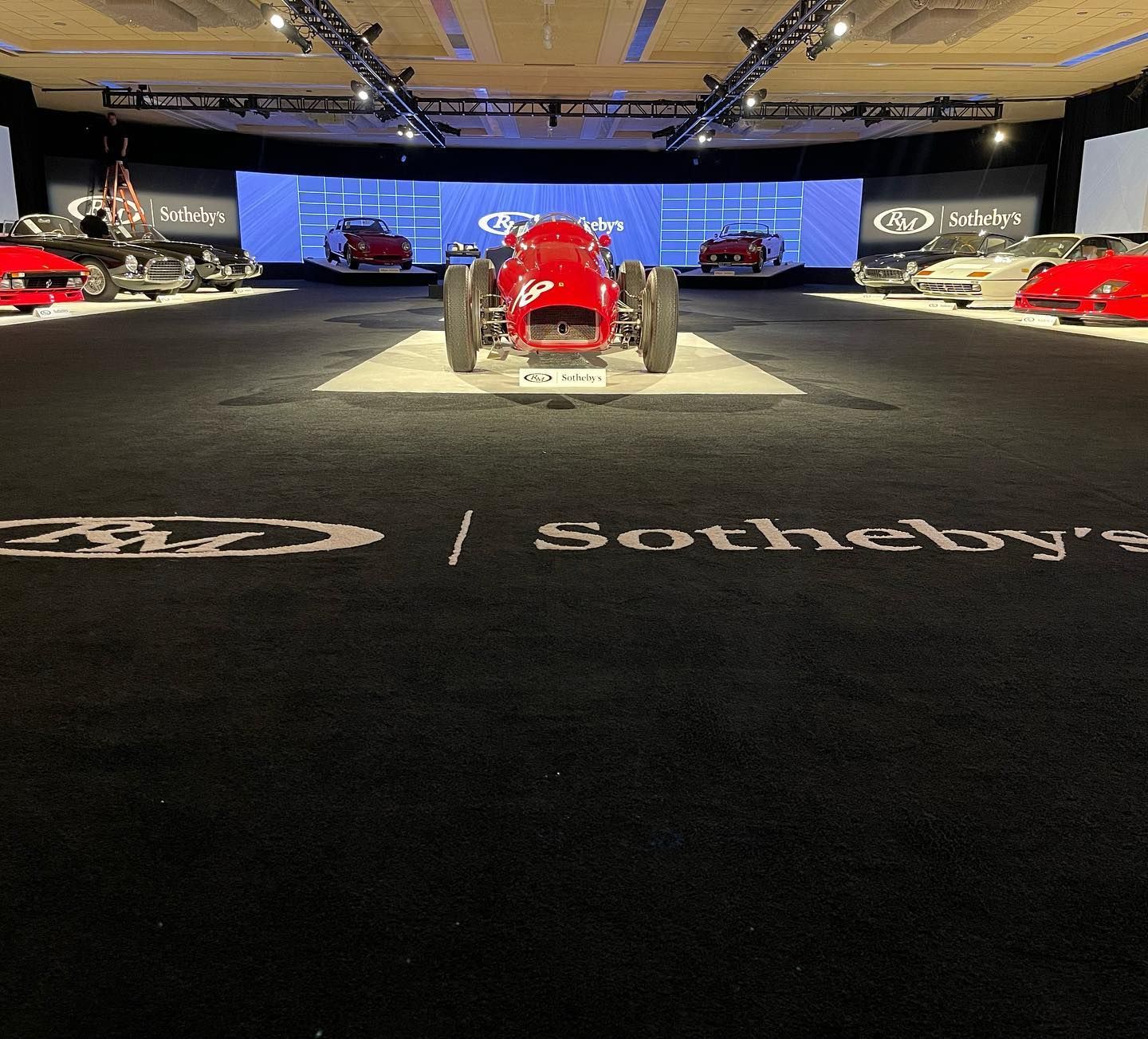 Las Vegas Event Flooring portfolio sample showing red car on carpeted event for Sotheby's.
