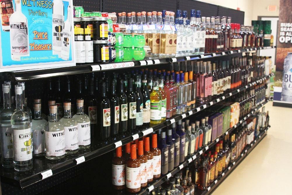 Rows of assorted liquor bottles on shelves in a retail store.