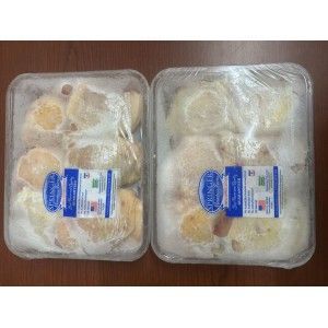Two rectangular plastic containers of Springer Mountain Farms frozen chicken pieces, positioned side-by-side on a desk.