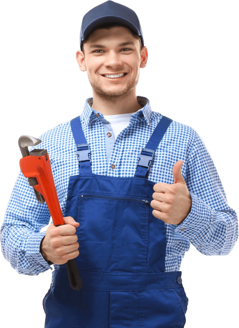 Smiling mechanic in blue overalls holding a red pipe wrench and giving a thumbs-up
