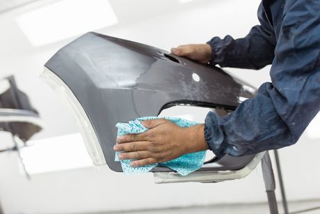 Body Painting — Man Preparing Bumper for Painting in Paducah, KY