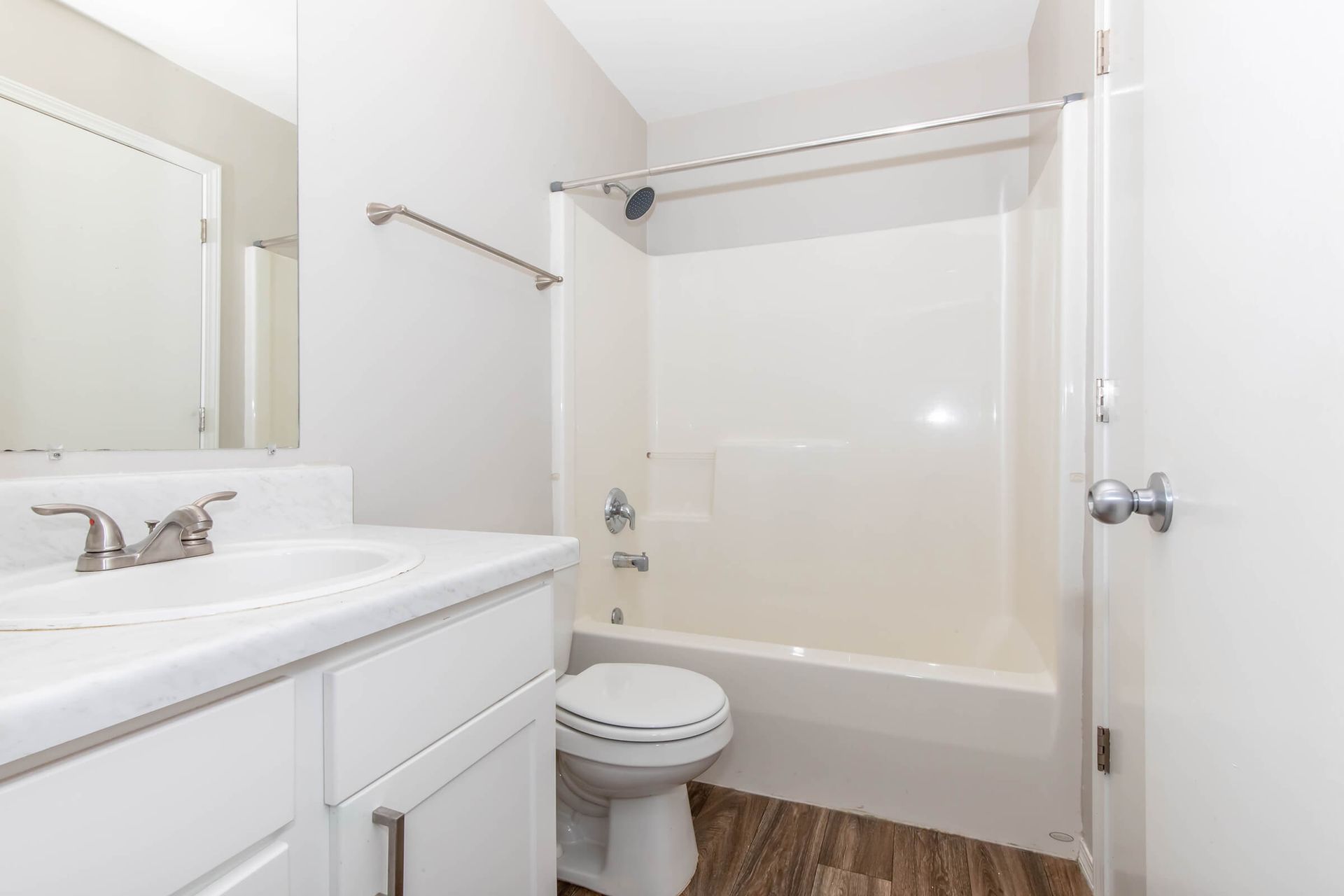 A bathroom with a sink , toilet , and bathtub.