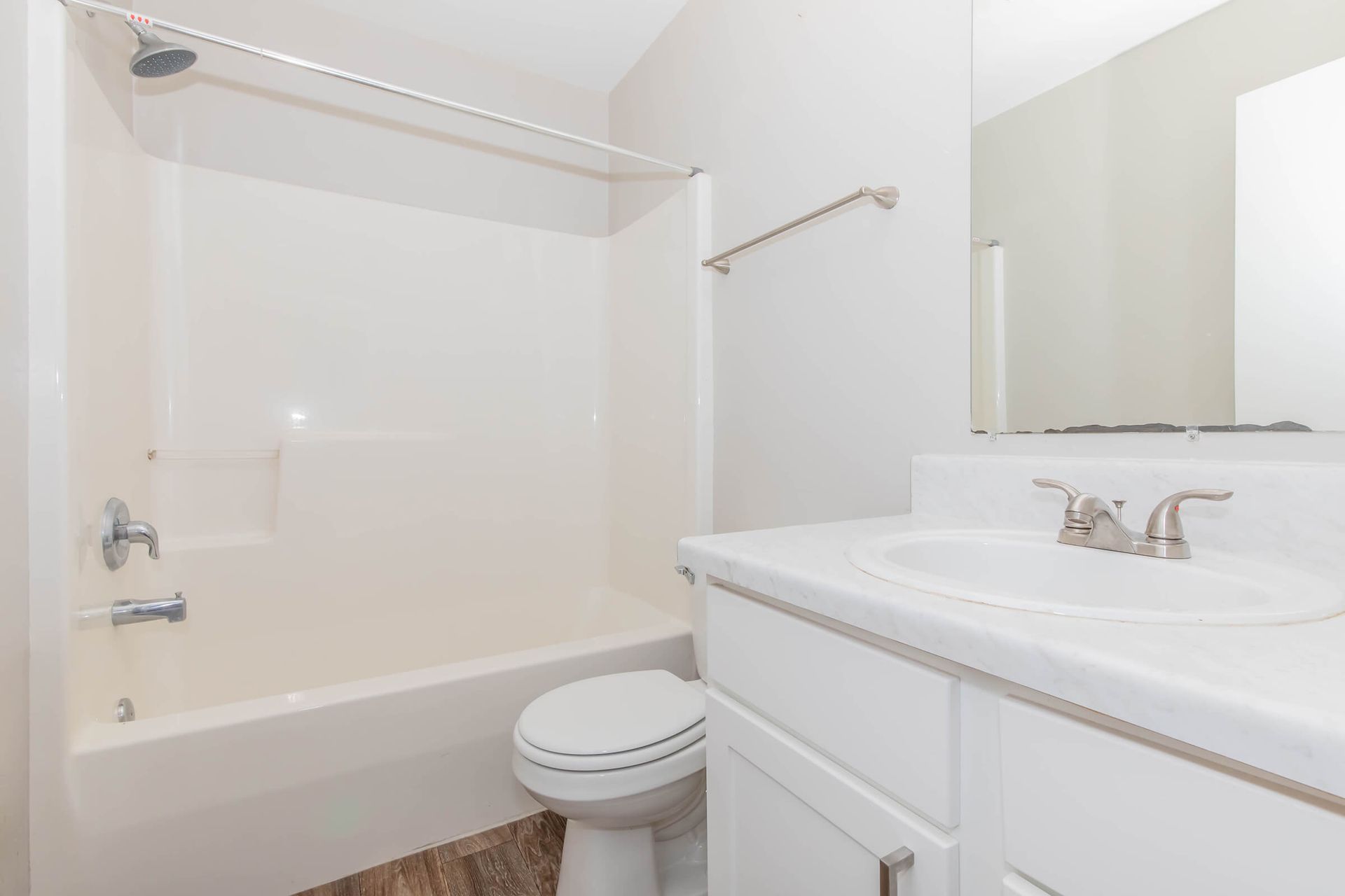 A bathroom with a toilet , sink , and bathtub.
