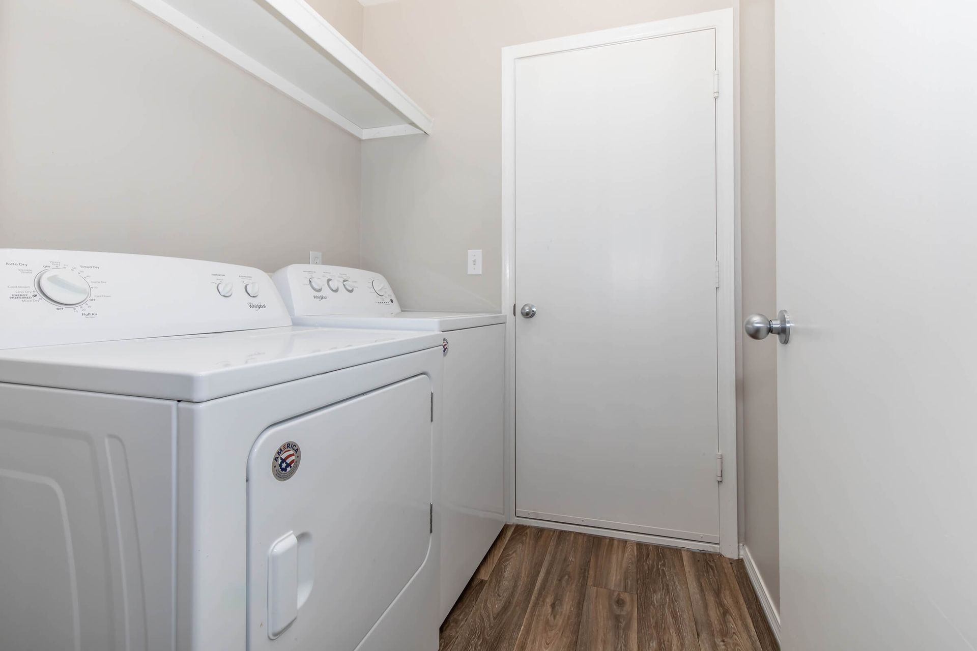 A laundry room with a washer and dryer in it.