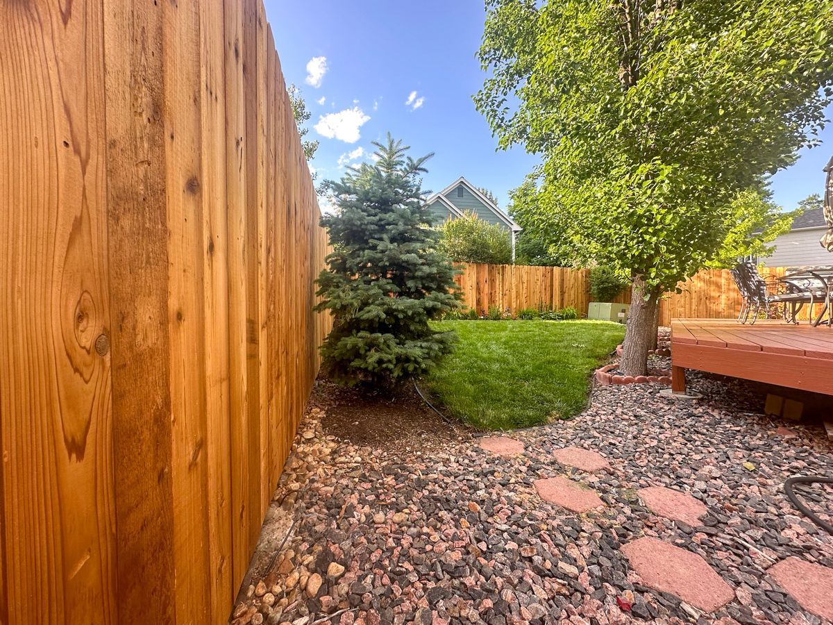 Dark brown vertical fence with textured surface.