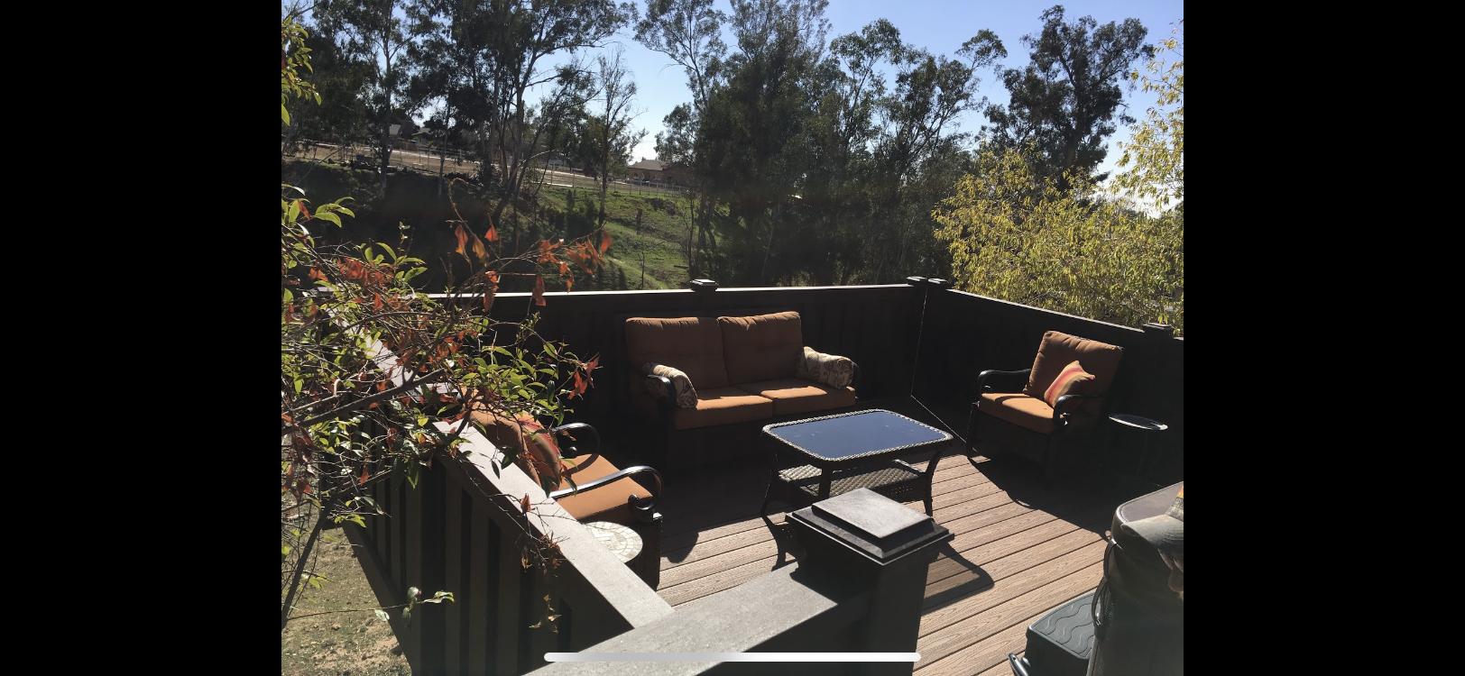 Brown horizontal slat fence with black posts.