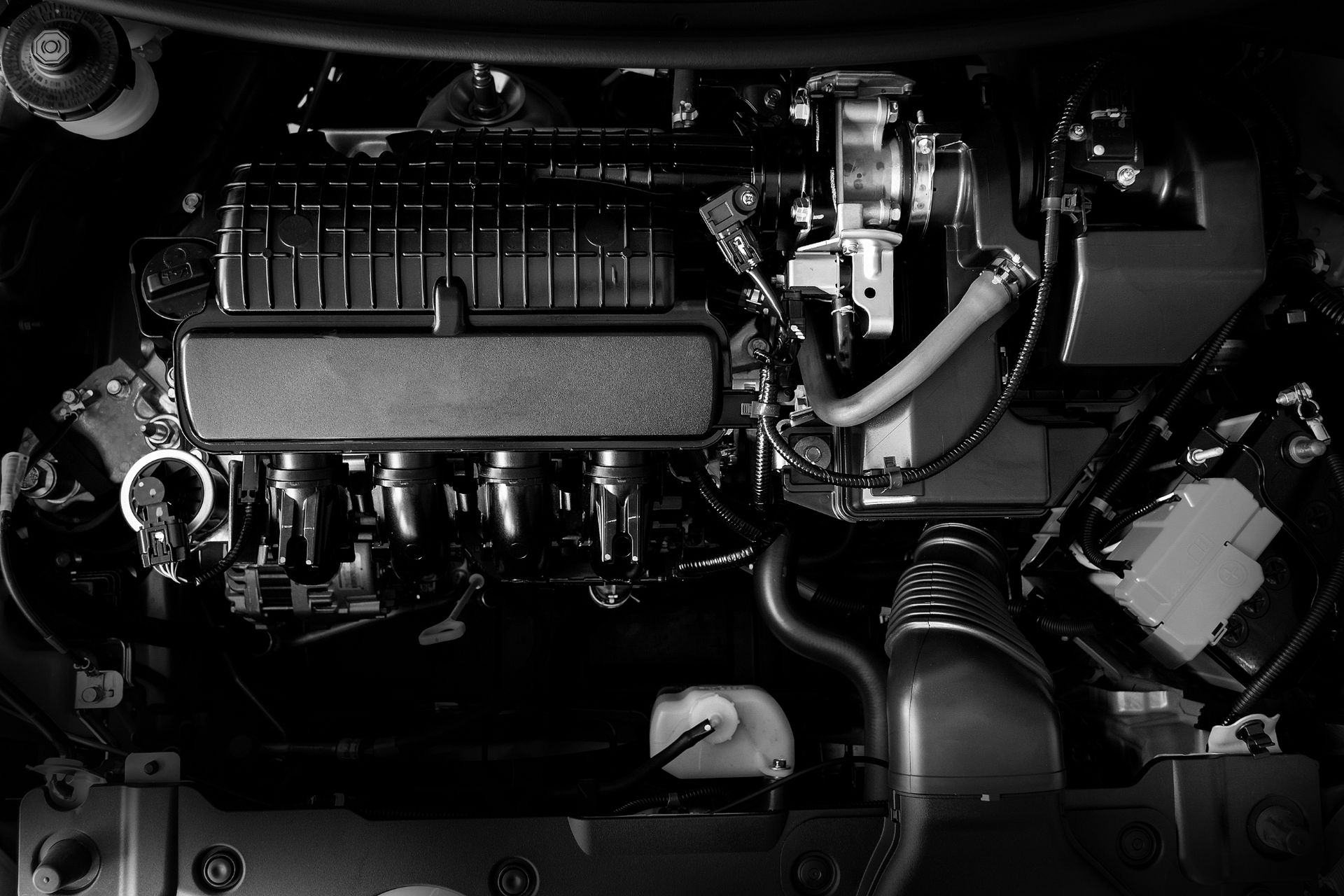 A black and white photo of the engine of a car.