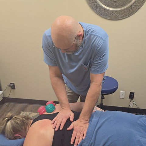Lance Thompson giving a woman a massage on her back