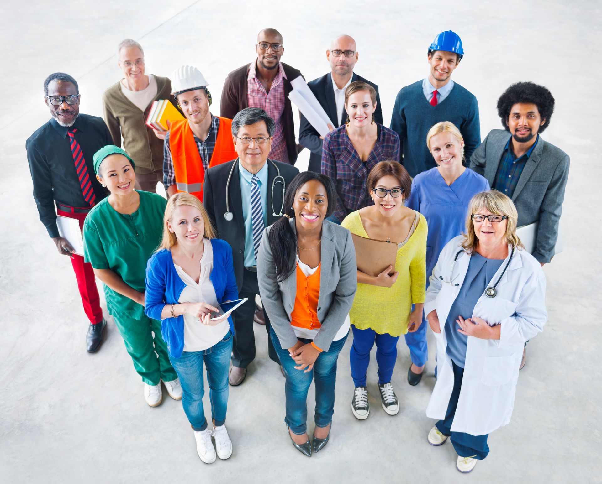 Group of people in various professional attire, looking up; white background.