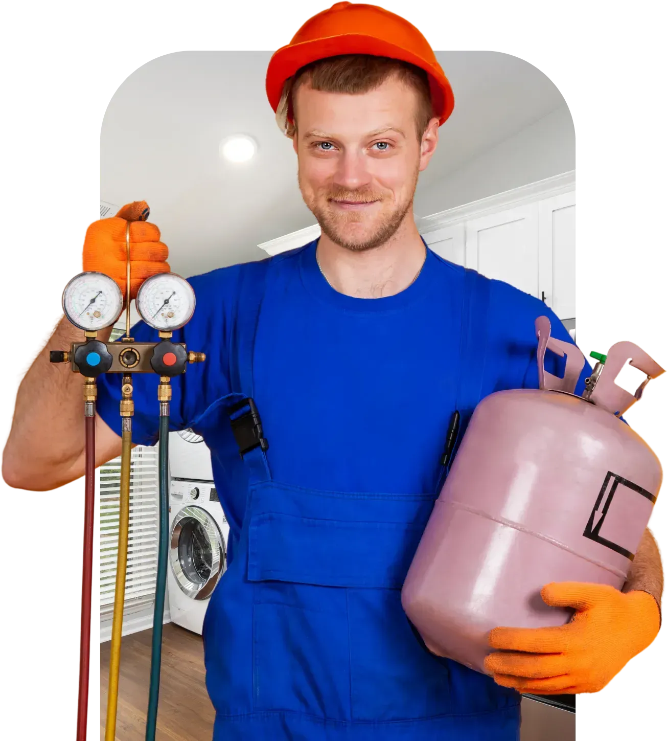 HVAC technician in blue jumpsuit, orange gloves, and hardhat, holding gauges and refrigerant tank.