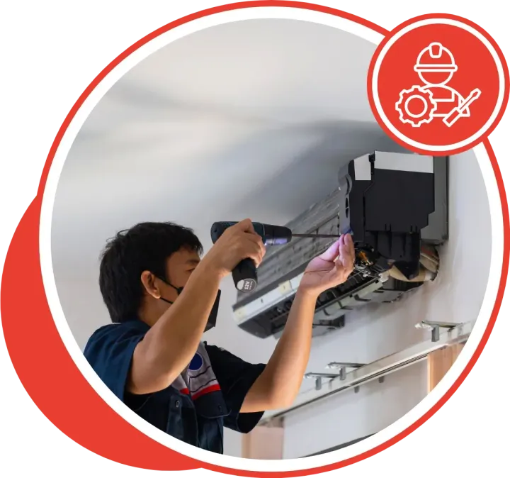 Man in uniform fixing air conditioner with a drill; red circle framing.