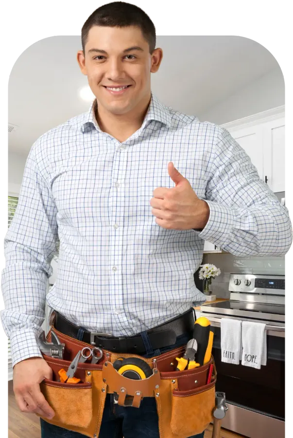 Man with tool belt giving a thumbs up in a kitchen.