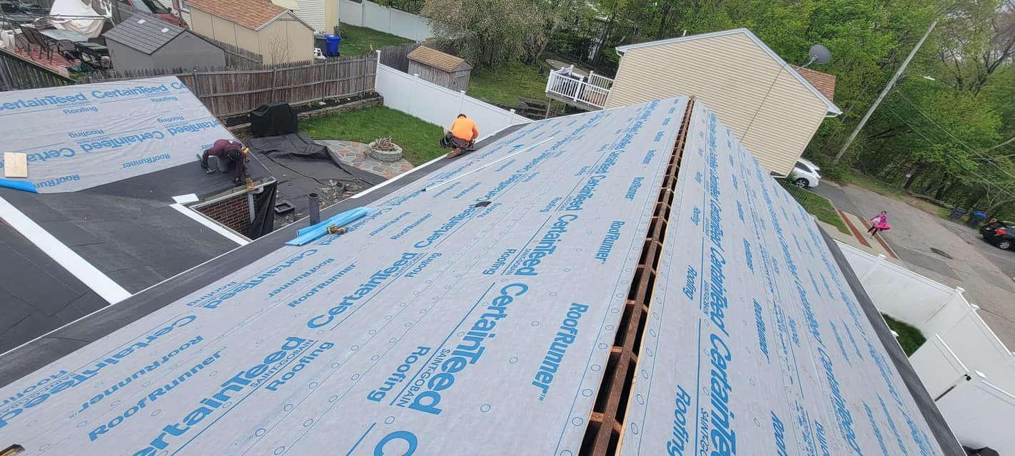 An aerial view of a roof being installed on a house.