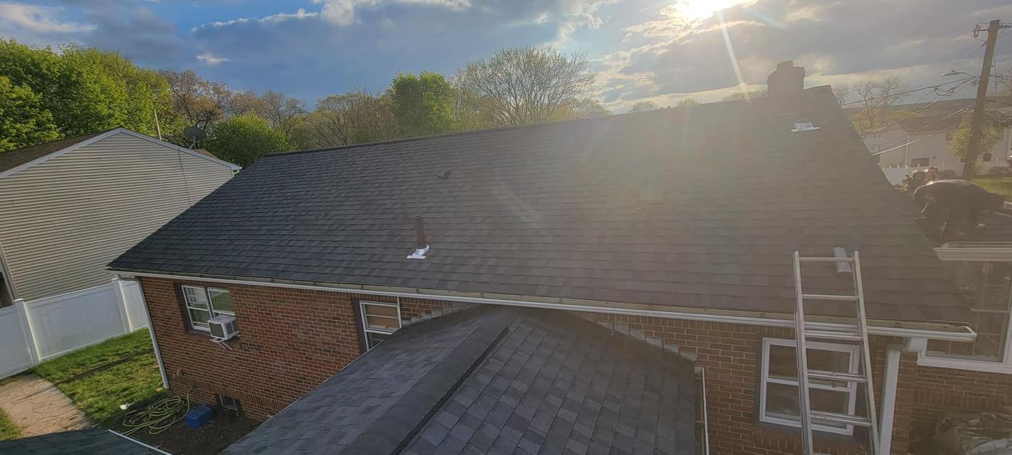 A ladder is sitting on the roof of a house.