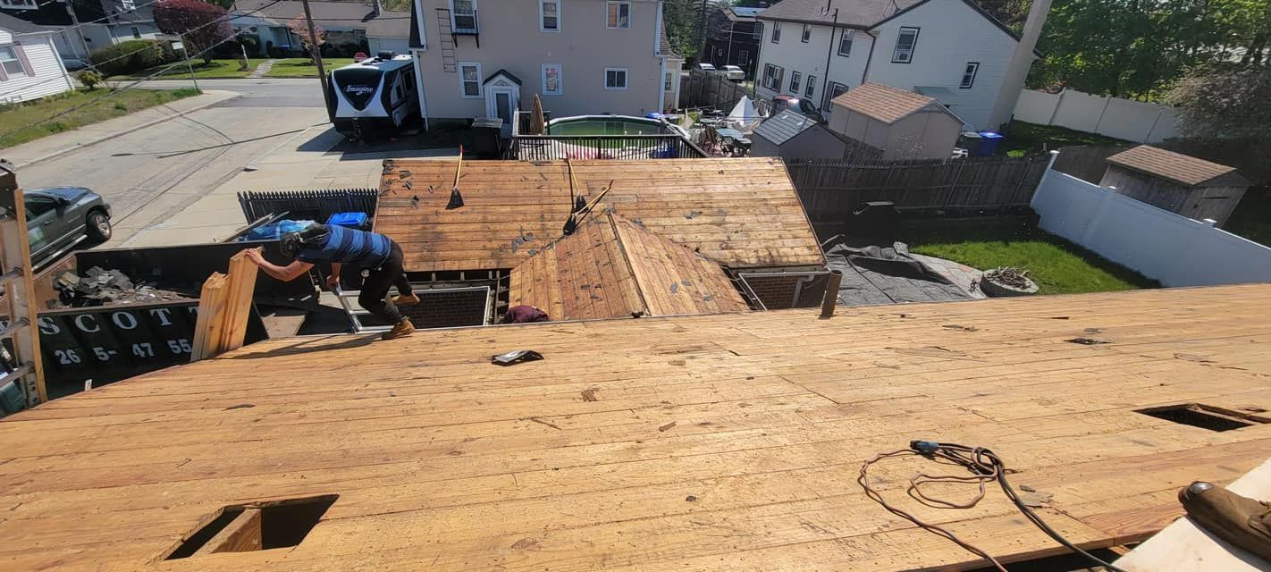 A roof is being repaired in a residential neighborhood.