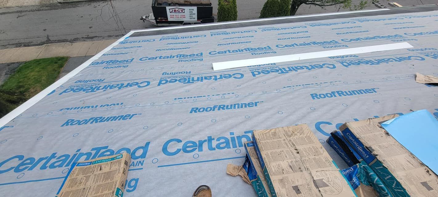 A roof is being covered with a certain brand roofing material.