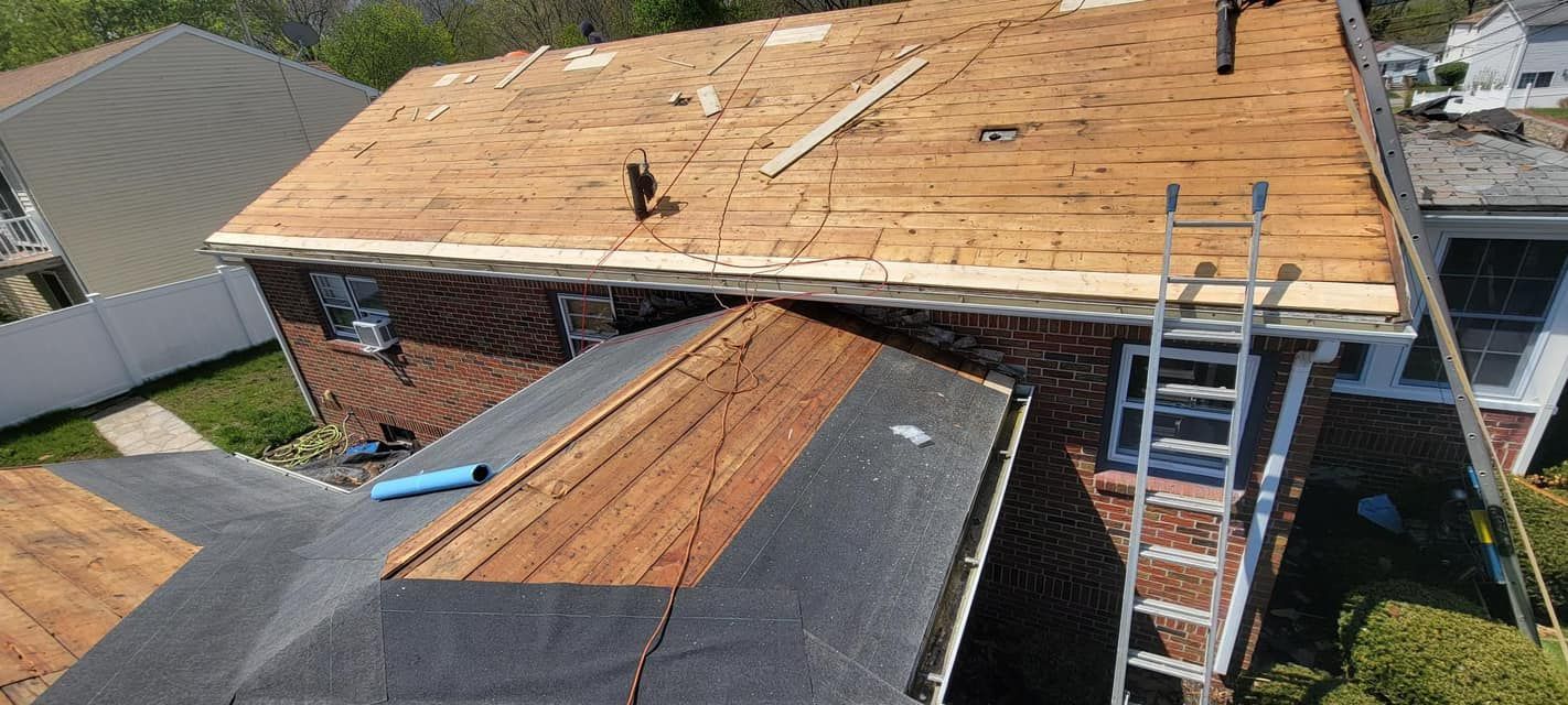 An aerial view of a house with a ladder on the roof.