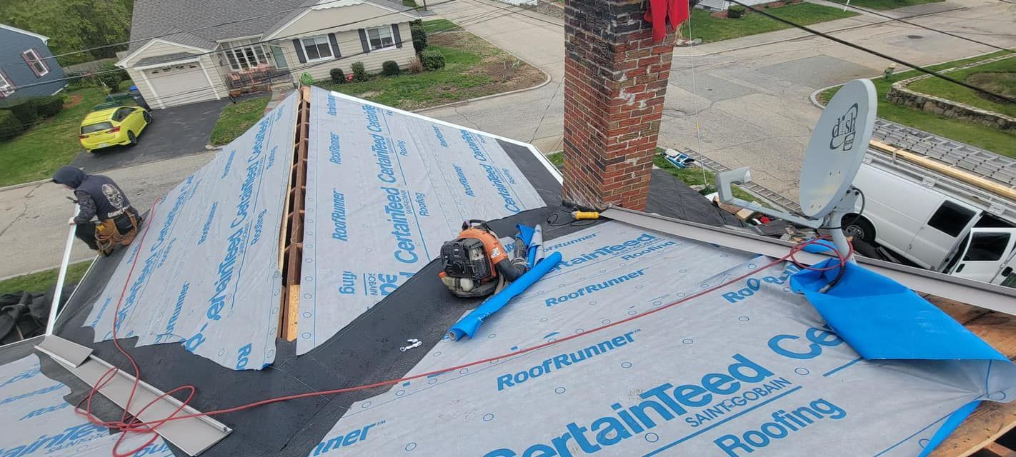 An aerial view of a roof being installed on a house.