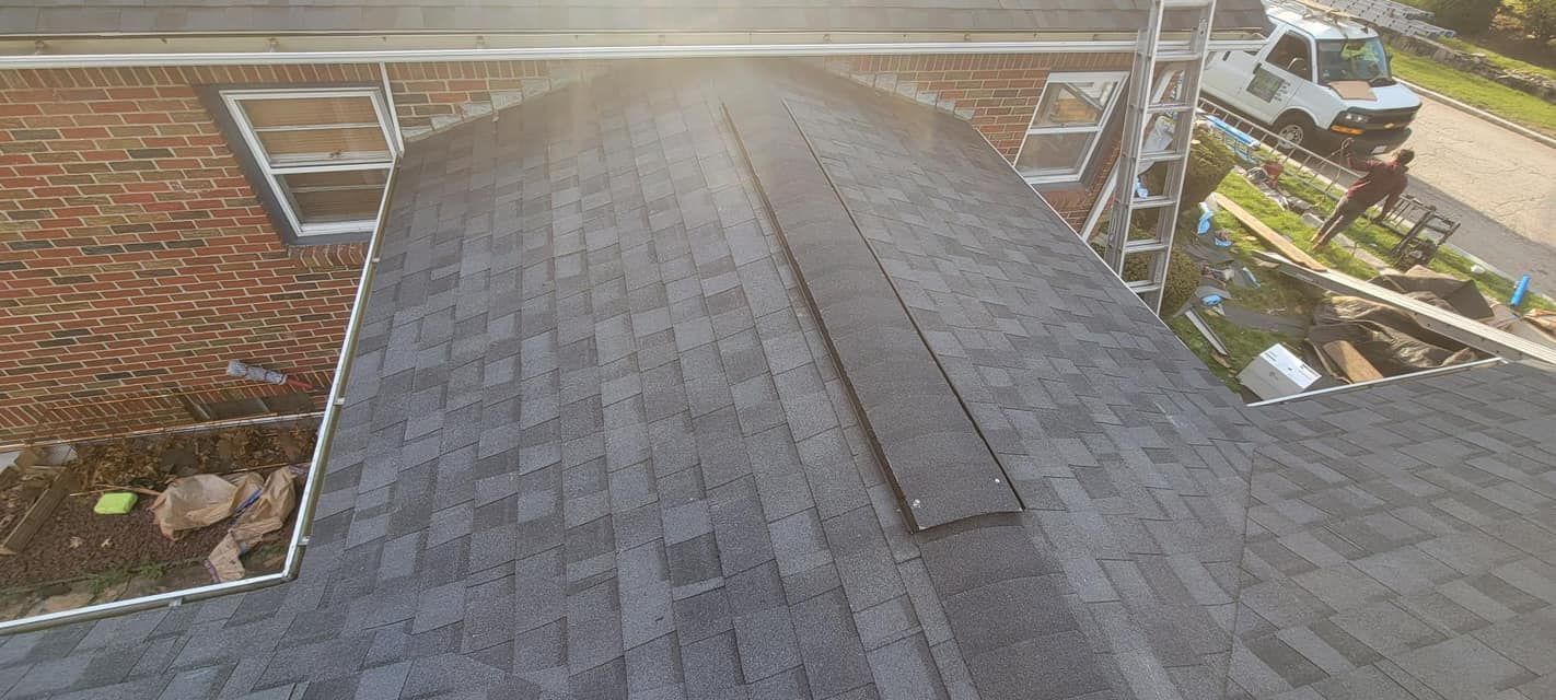 A roof with shingles being installed on a house.