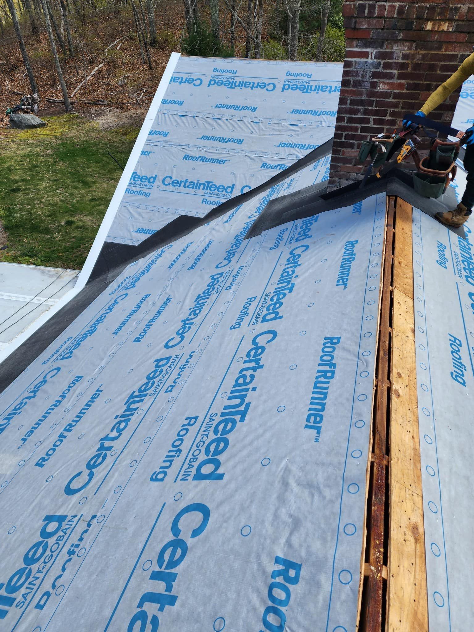 A person is working on a roof with a machine.