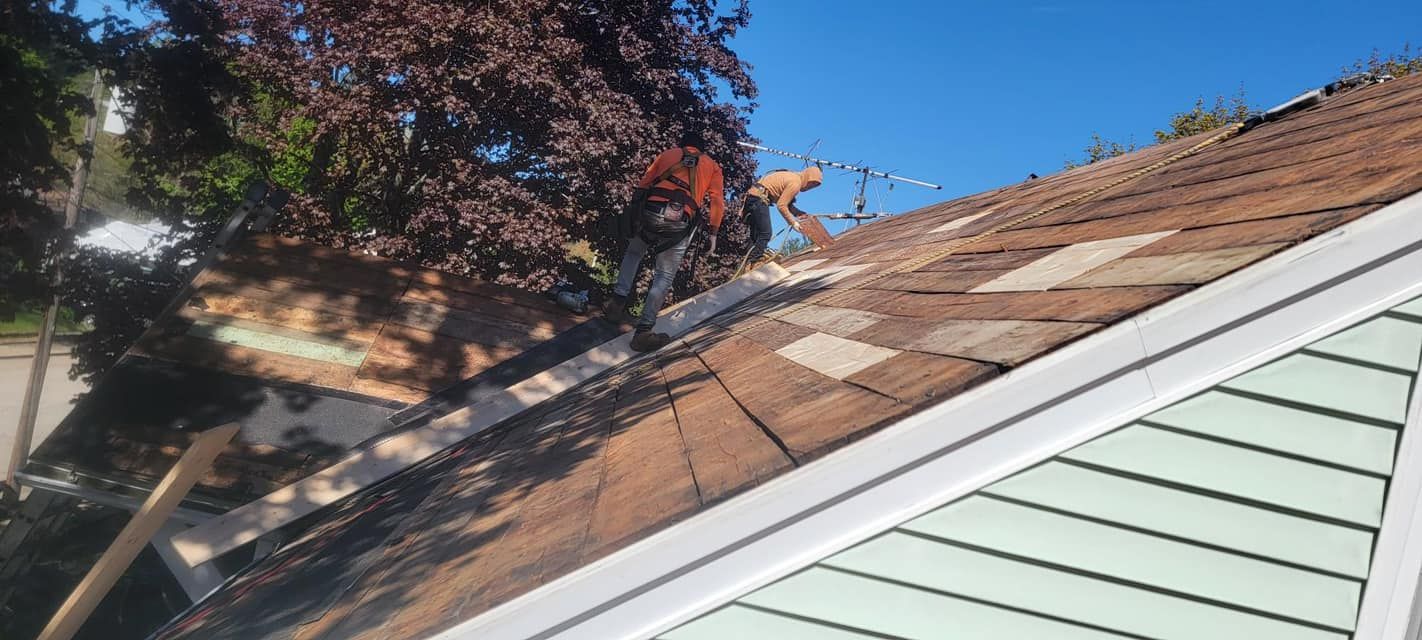 A man is working on the roof of a house.