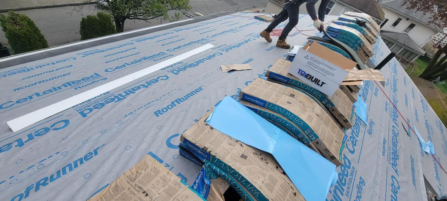 A group of people are working on a roof.