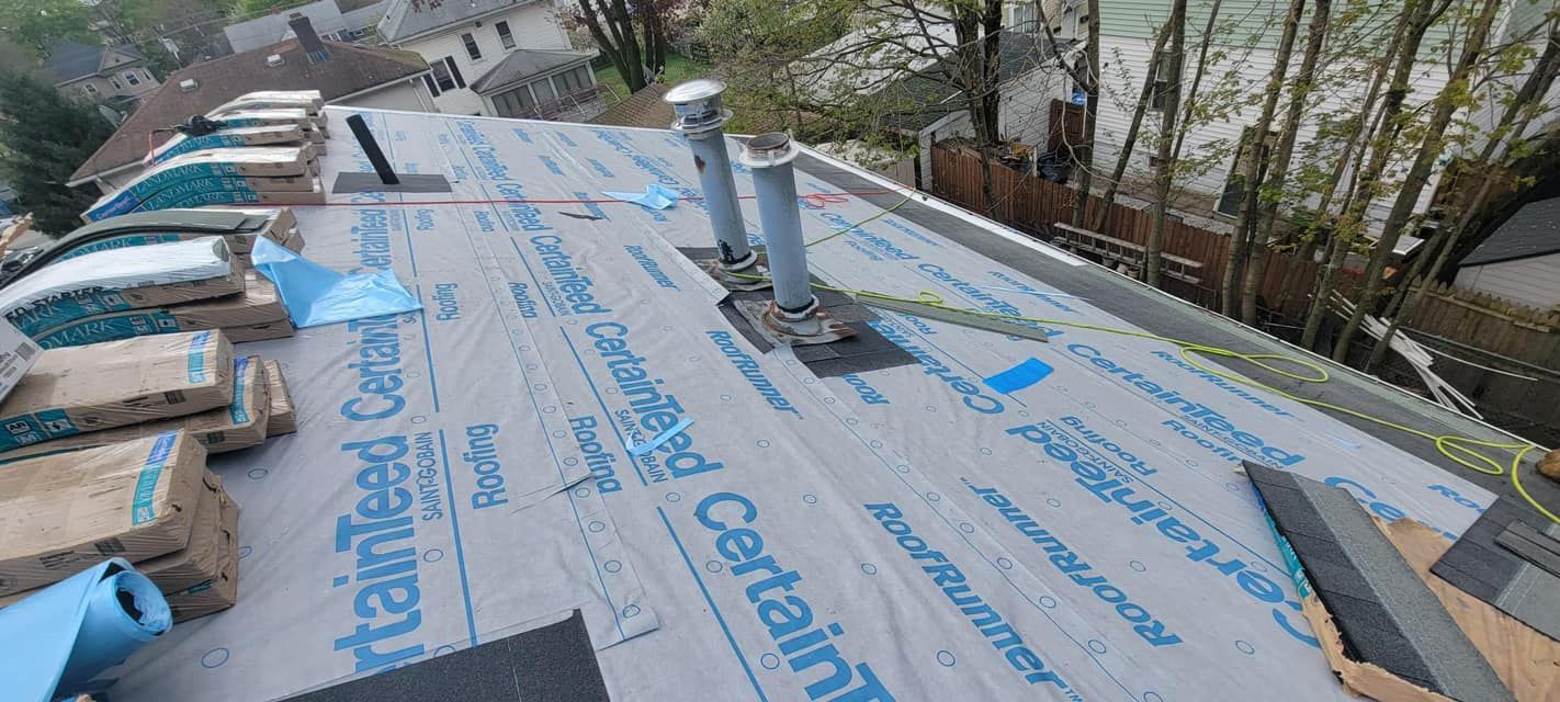 A roof with a lot of roofing material on it.