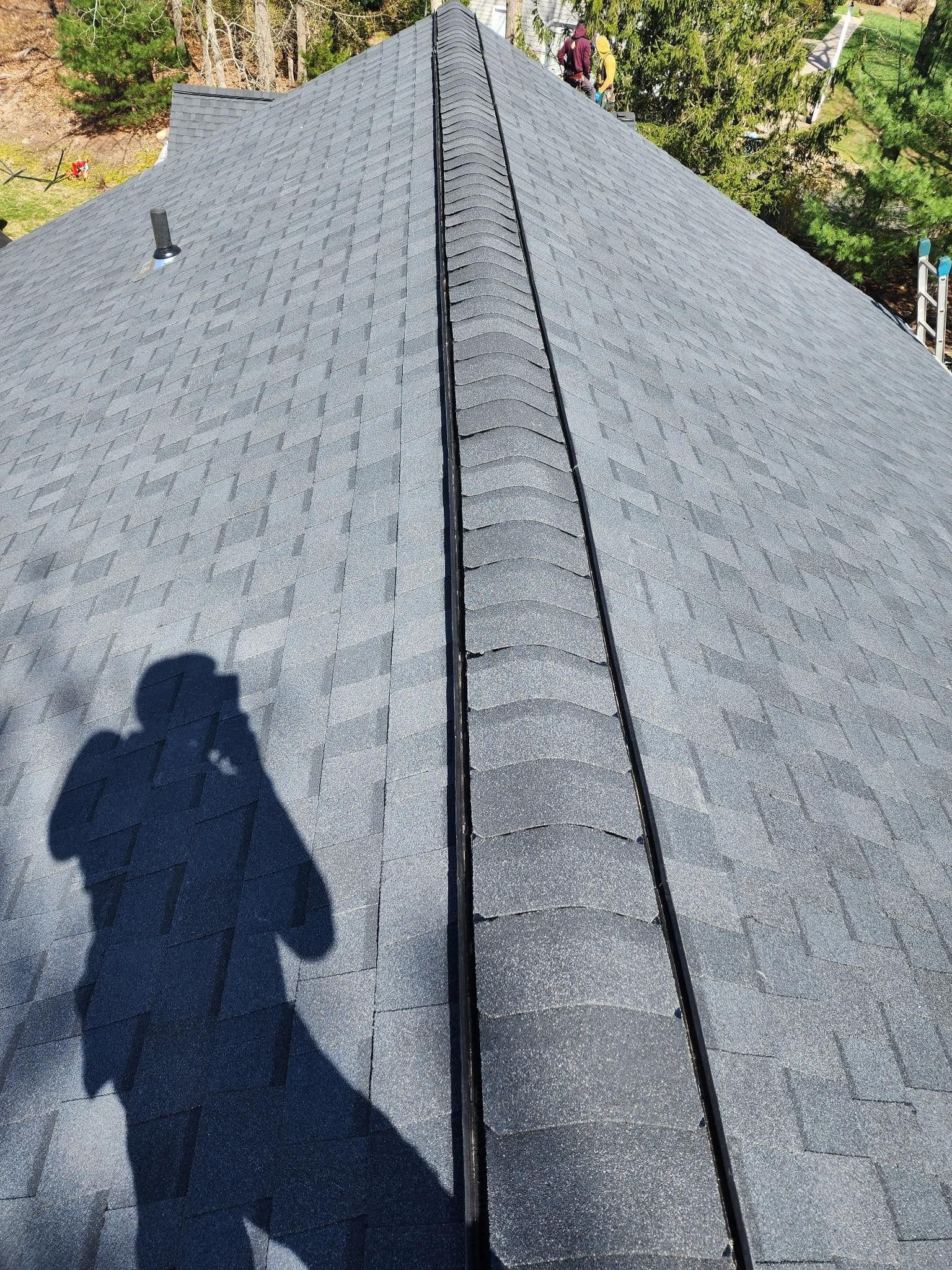 A person is taking a picture of a roof with a camera.