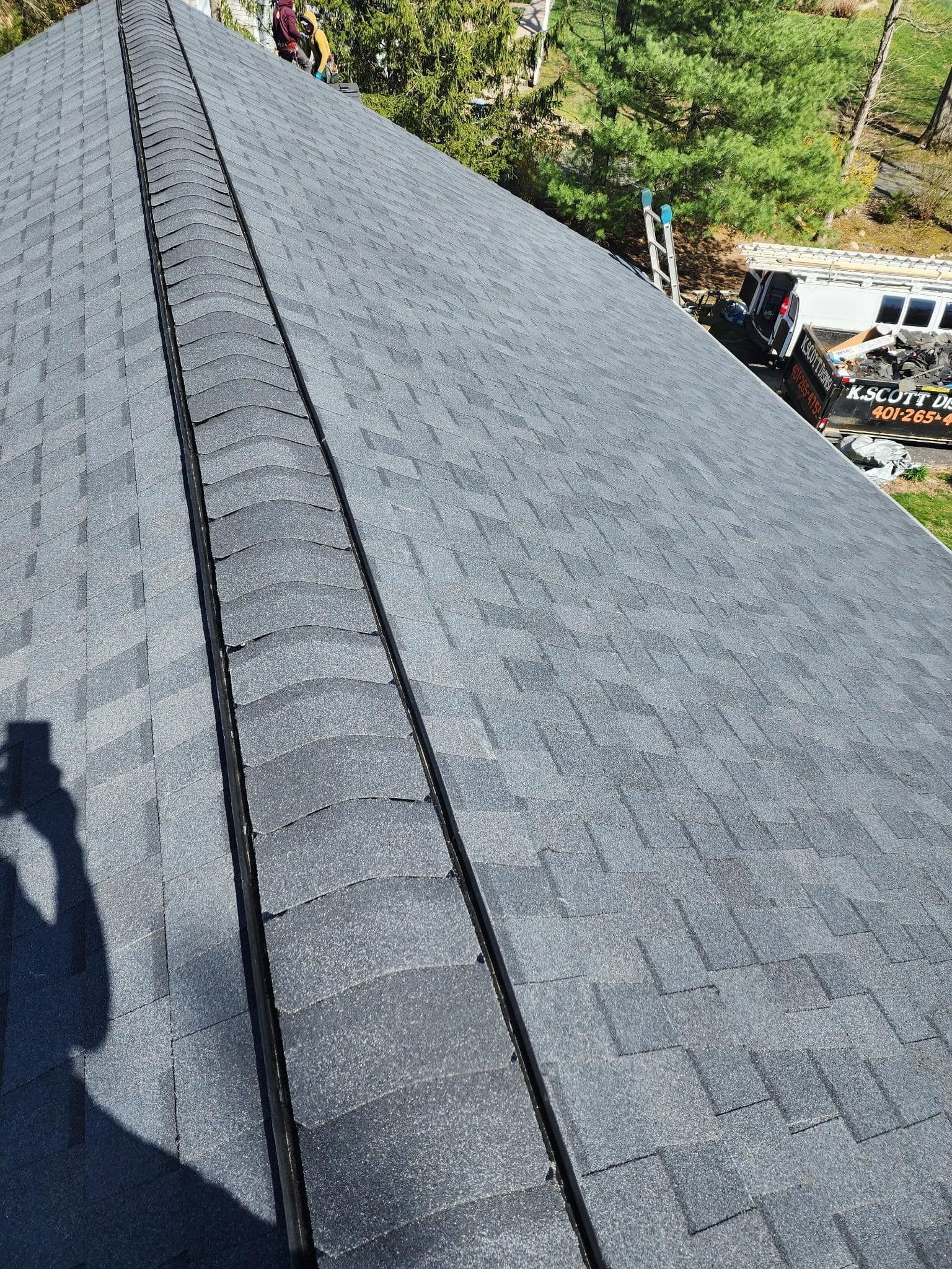 A person is taking a picture of a roof with a camera.